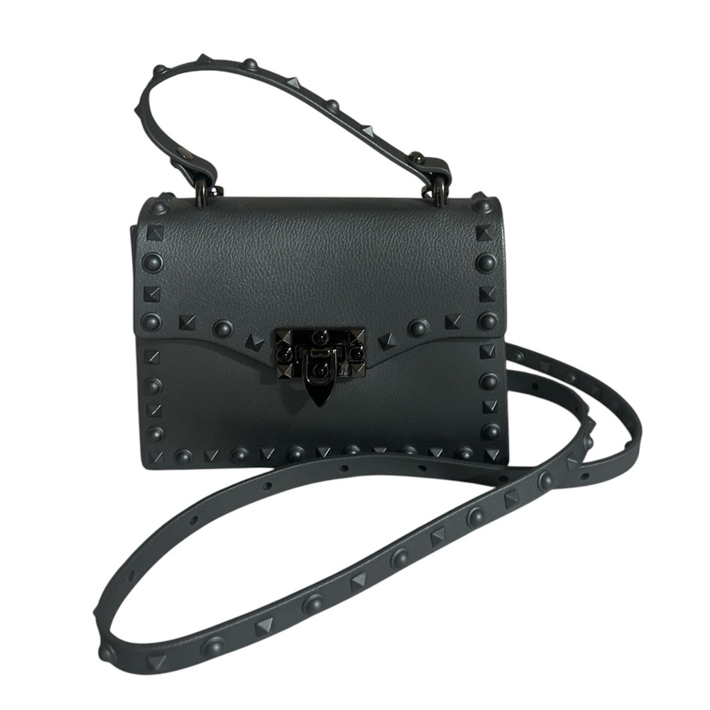 Edgy, jelly bag features a a rock studded border detail with black metal